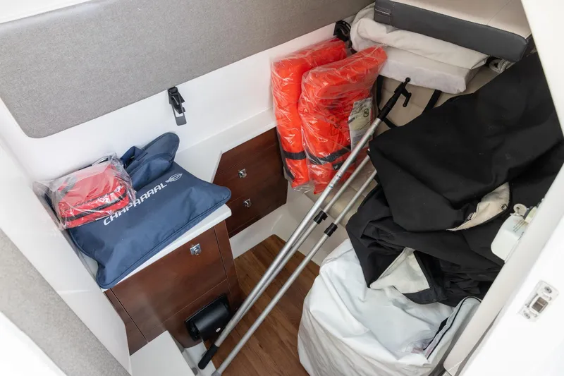 Slide: The Image of 2021 Chaparral 280 OSX cabin storage with life jackets and boating gear. - 12