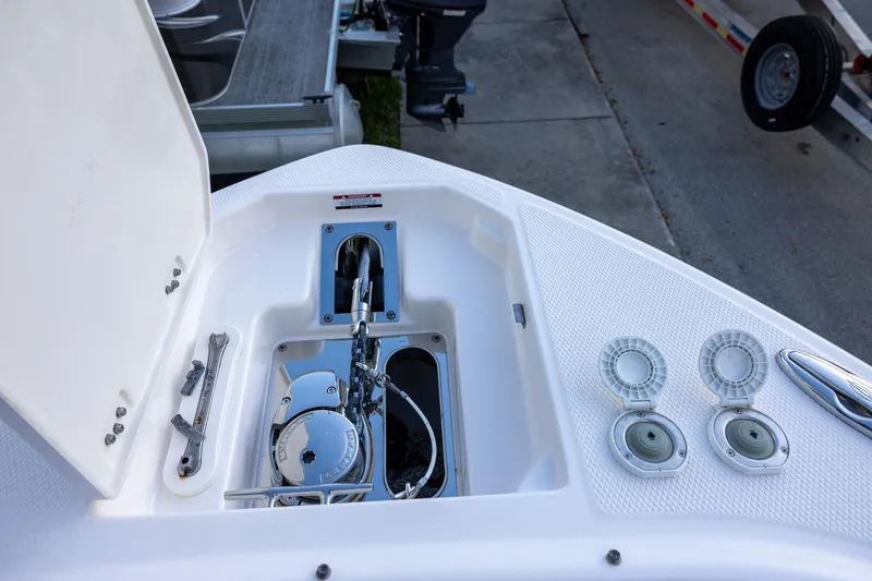 Slide: The Image of 2021 Chaparral 280 OSX boat anchor compartment with open hatch and cleats. - 14