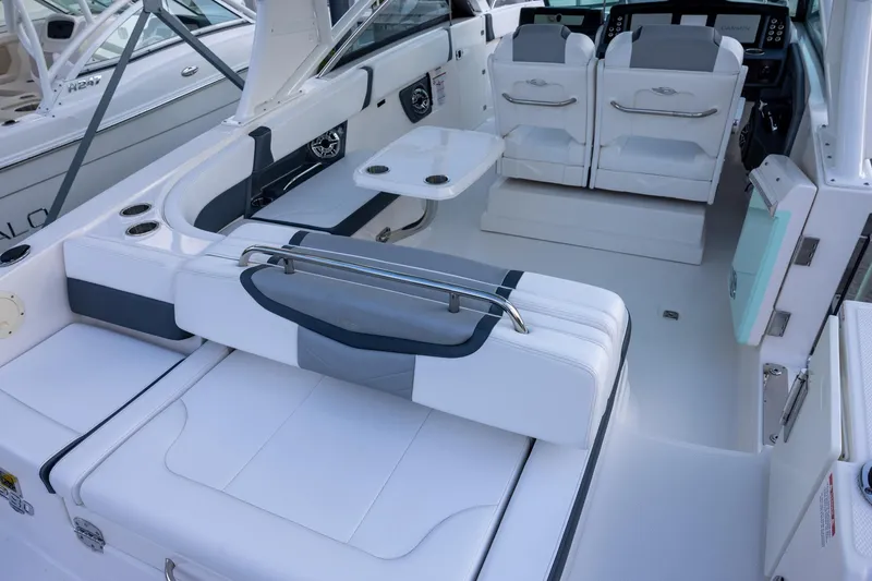Slide: The Image of 2021 Chaparral 280 OSX boat interior with white seating and modern design. - 18