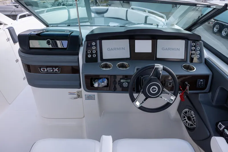 Slide: The Image of Cockpit of 2021 Chaparral 280 OSX boat with Garmin displays and steering wheel. - 7