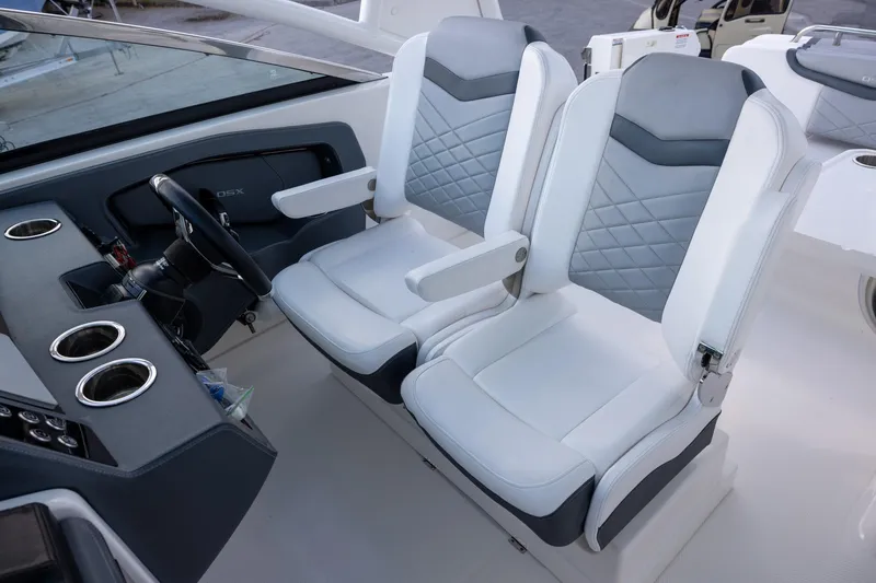 Slide: The Image of 2021 Chaparral 280 OSX boat interior with dual captain seats and steering console. - 8