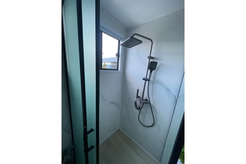 Slide: The Image of Modern shower in 2025 ALLHOUSE HB-1250 houseboat, featuring sleek design and frosted glass door. - 10