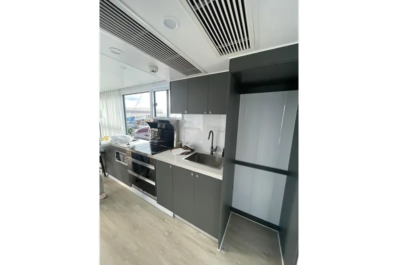 Slide: The Image of Modern kitchen interior on 2025 Houseboat ALLHOUSE HB-1250, featuring sleek cabinetry and appliances. - 12