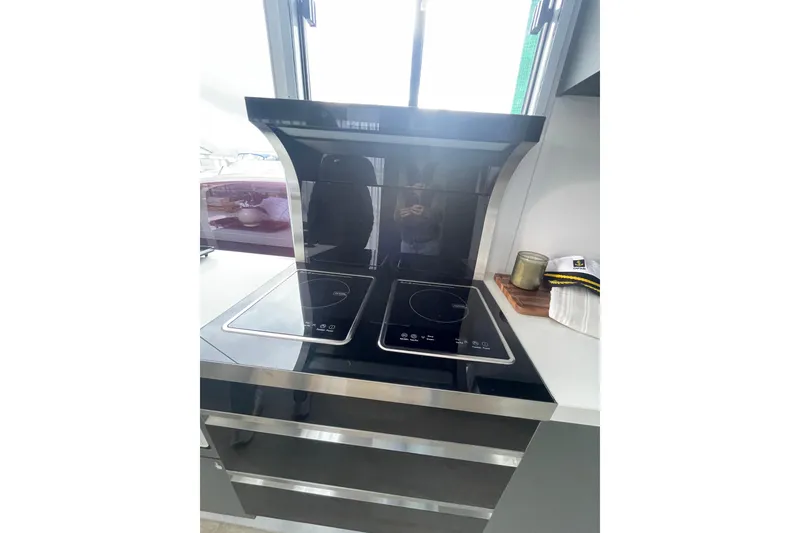 Slide: The Image of Modern kitchen stove on 2025 ALLHOUSE HB-1250 houseboat, featuring sleek induction cooktop. - 13