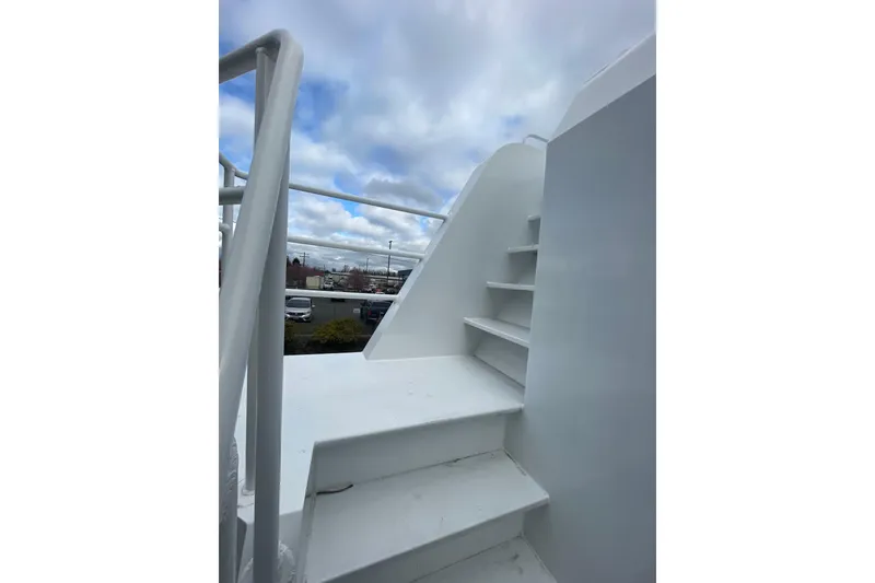 Slide: The Image of Staircase on 2025 Houseboat ALLHOUSE HB-1250 under a cloudy sky. - 4