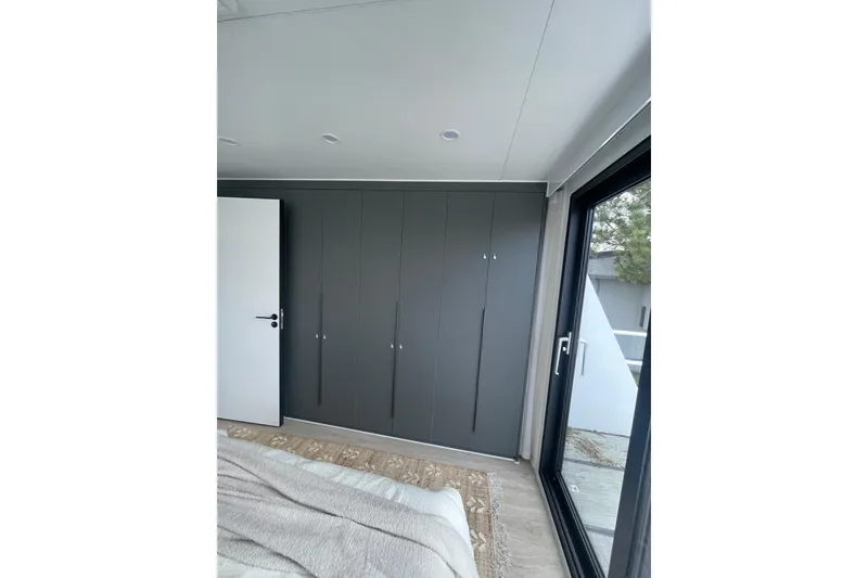 Slide: The Image of Modern interior of 2025 Houseboat ALLHOUSE HB-1250 with sleek design and large window. - 6