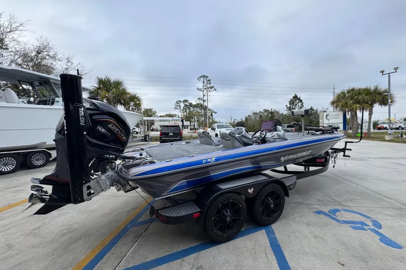 Slide: The Image of 2023 Phoenix 21 PHX boat with Yamaha engine, parked outdoors on a trailer. - 11