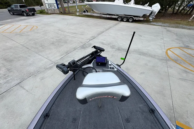 Slide: The Image of 2023 Phoenix 21 PHX boat with advanced navigation equipment, parked outdoors. - 18