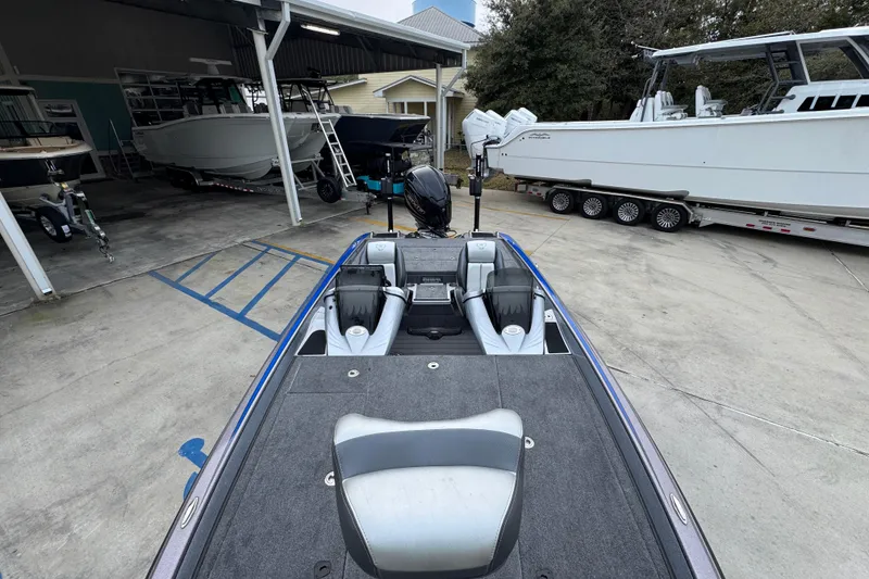 Slide: The Image of 2023 Phoenix 21 PHX boat parked in a marina with other boats. - 22