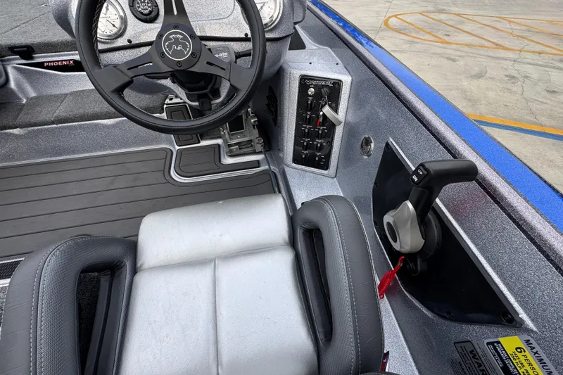Slide: The Image of 2023 Phoenix 21 PHX boat interior with steering wheel and control panel. - 29