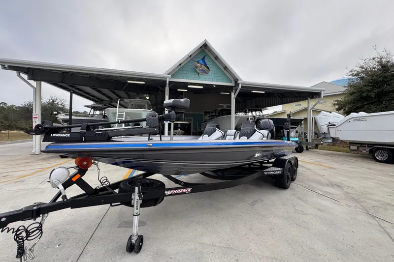 Slide: The Image of 2023 Phoenix 21 PHX boat on trailer outside a marine dealership. - 3