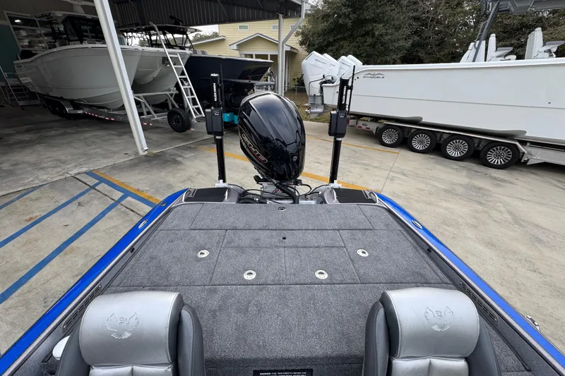 Slide: The Image of 2023 Phoenix 21 PHX boat with motor, parked in a marina storage area. - 32