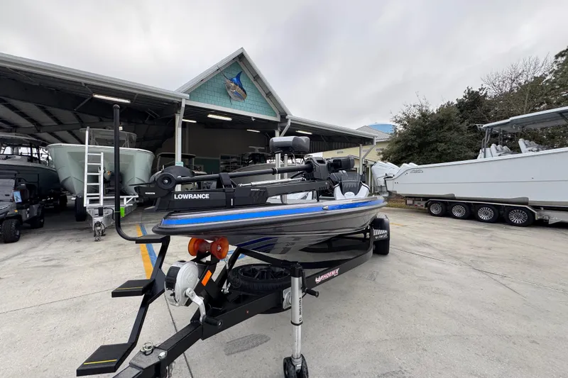 Slide: The Image of 2023 Phoenix 21 PHX boat on trailer at marina, featuring Lowrance equipment. - 4