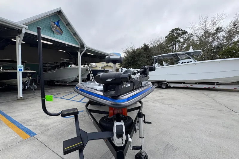 Slide: The Image of 2023 Phoenix 21 PHX boat on trailer at marina, surrounded by other boats. - 5