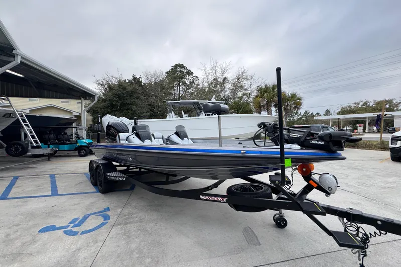Slide: The Image of 2023 Phoenix 21 PHX boat on trailer in parking lot, overcast sky. - 8