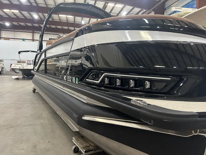 Slide: The Image of 2025 Harris Grand Mariner 250 pontoon boat in a warehouse. - 25