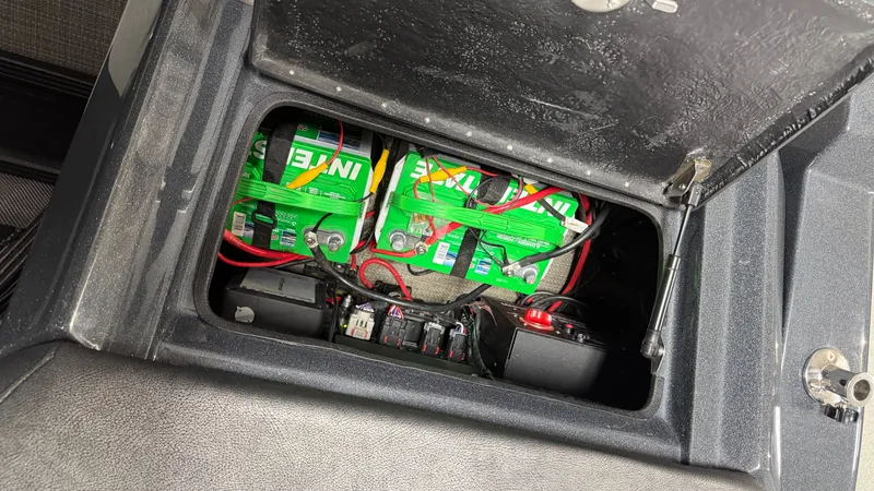 Slide: The Image of Battery compartment of a 2018 Crest Caribbean boat with green batteries. - 24