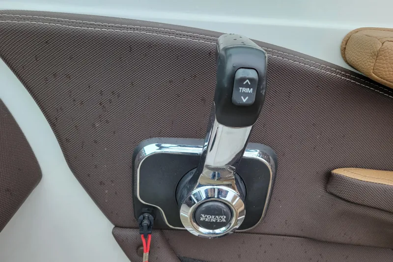 Slide: The Image of Throttle control lever on a 2019 Cobalt CS22 boat with Volvo Penta trim buttons. - 12