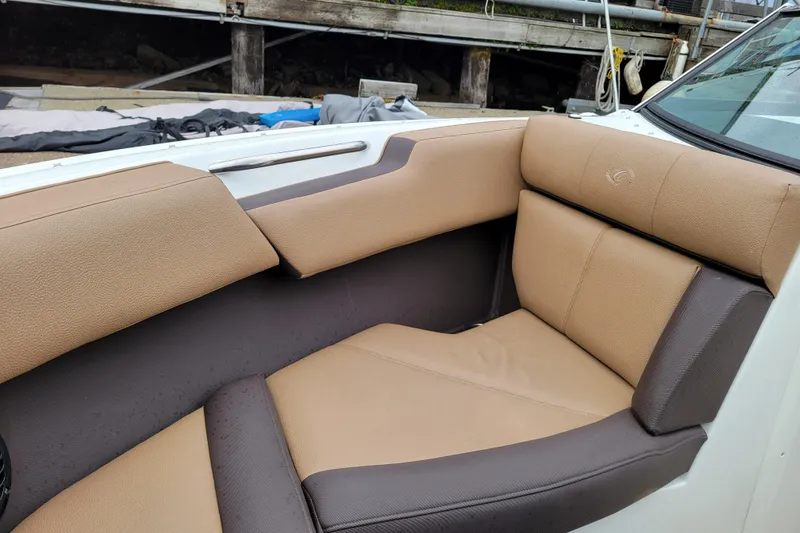 Slide: The Image of 2019 Cobalt CS22 boat interior with tan and brown seating, dockside view. - 15