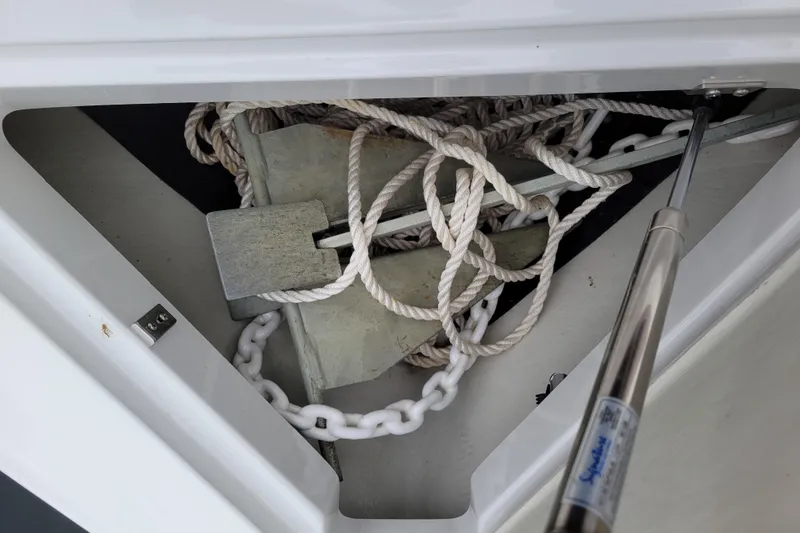 Slide: The Image of Anchor and rope storage in 2019 Cobalt CS22 boat compartment. - 16
