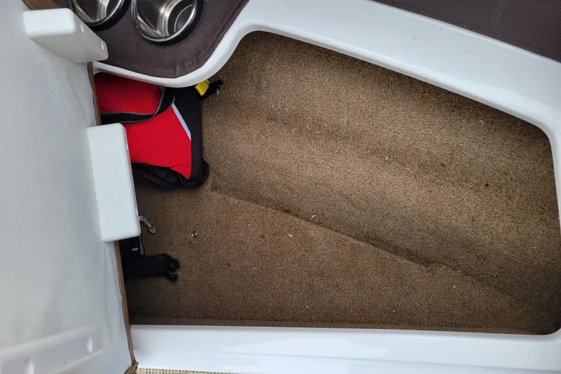 Slide: The Image of Interior of a 2019 Cobalt CS22 boat with carpet and life jacket. - 18