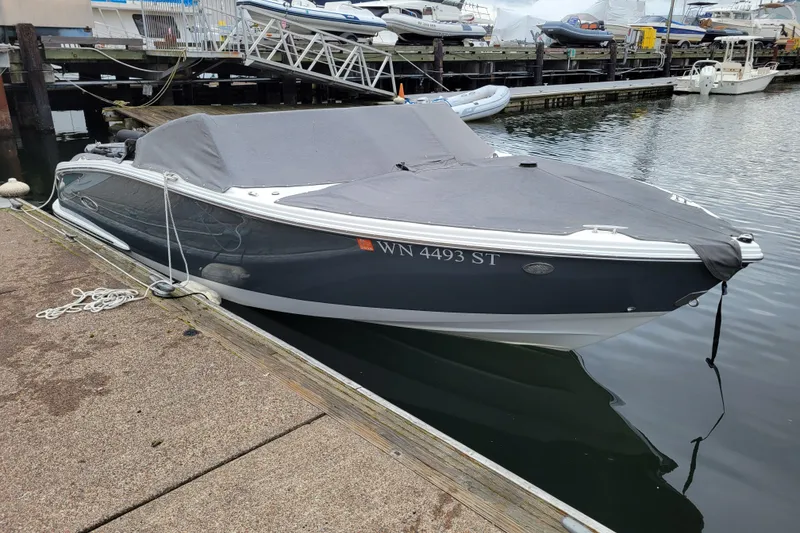 Slide: The Image of 2019 Cobalt CS22 boat docked with cover, marina background. - 27