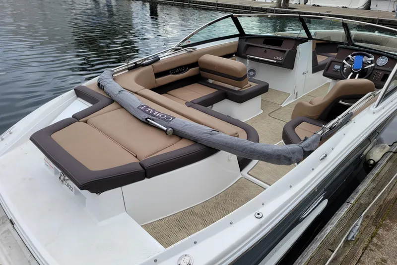 Slide: The Image of 2019 Cobalt CS22 boat with tan interior, docked on calm water. - 3