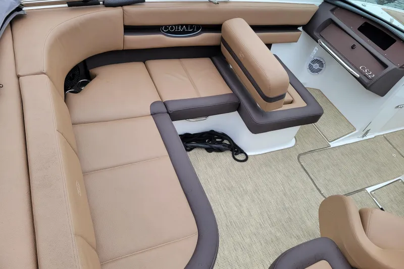 Slide: The Image of 2019 Cobalt CS22 boat interior with tan and brown seating, showcasing luxury and comfort. - 5