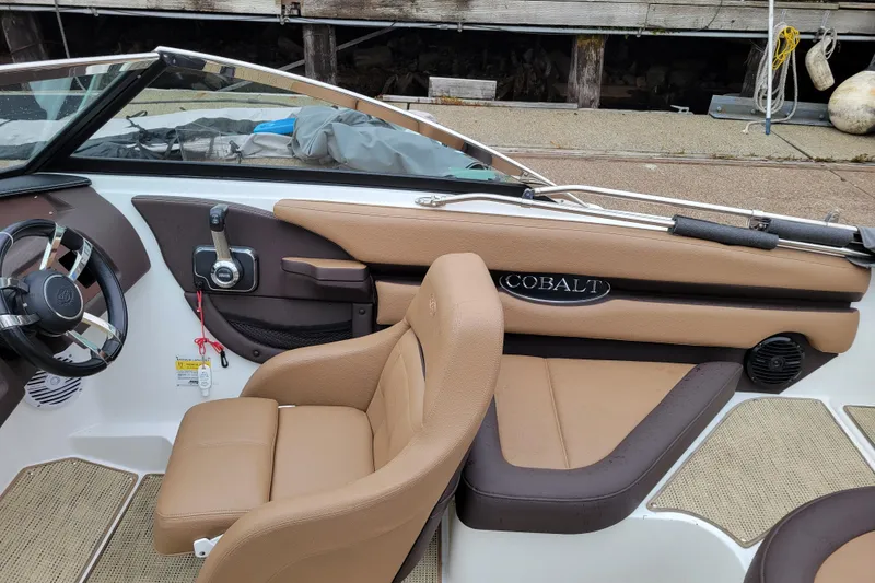 Slide: The Image of 2019 Cobalt CS22 boat interior with tan leather seats and steering wheel. - 6