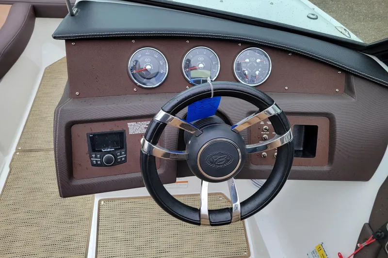 Slide: The Image of Steering wheel and dashboard of 2019 Cobalt CS22 boat with gauges and controls. - 8