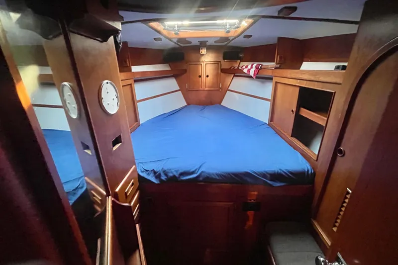 Slide: The Image of Interior of a 1982 Stevens cutter sailboat with wooden furnishings and seating area. - 10