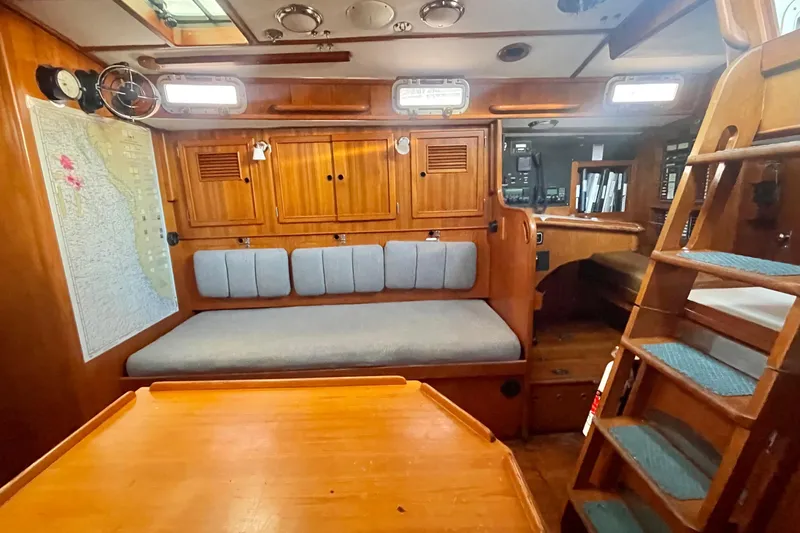 Slide: The Image of Interior of 1982 Stevens cutter sailboat with wooden furnishings and nautical map. - 15
