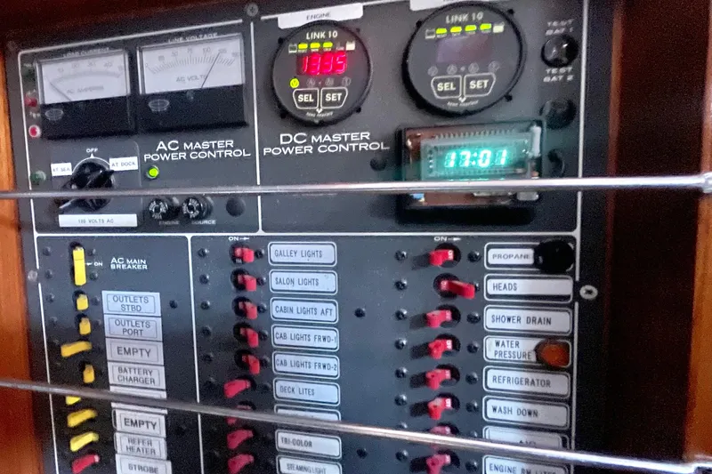 Slide: The Image of Electrical control panel on a 1982 Stevens cutter yacht, featuring AC and DC power controls. - 25