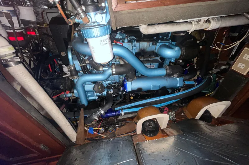 Slide: The Image of Engine compartment of a 1982 Stevens cutter sailboat, showcasing intricate mechanical components. - 26