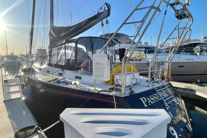 Slide: The Image of 1982 Stevens cutter sailboat docked in marina, sunlit with clear blue sky. - 3