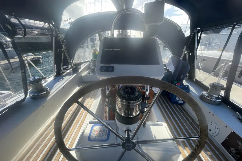 Slide: The Image of 1982 Stevens cutter sailboat cockpit with steering wheel and navigation equipment. - 6