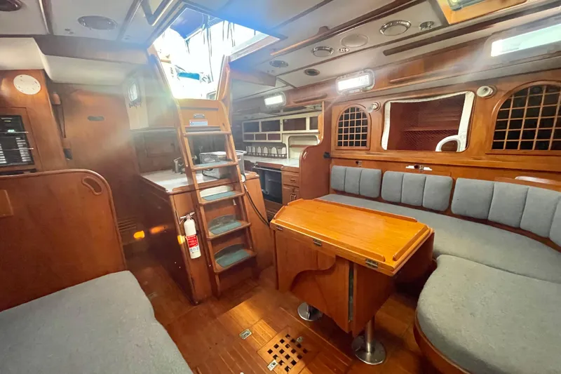 Slide: The Image of Cozy cabin interior of 1982 Stevens cutter with wooden finish and blue bedding. - 9