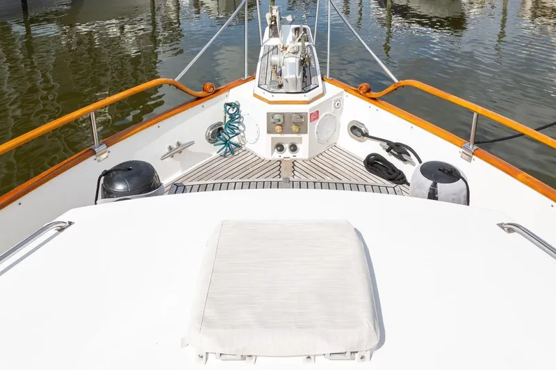 Slide: The Image of 1993 Grand Banks 46 Motoryacht deck with wooden rail and nautical equipment. - 14