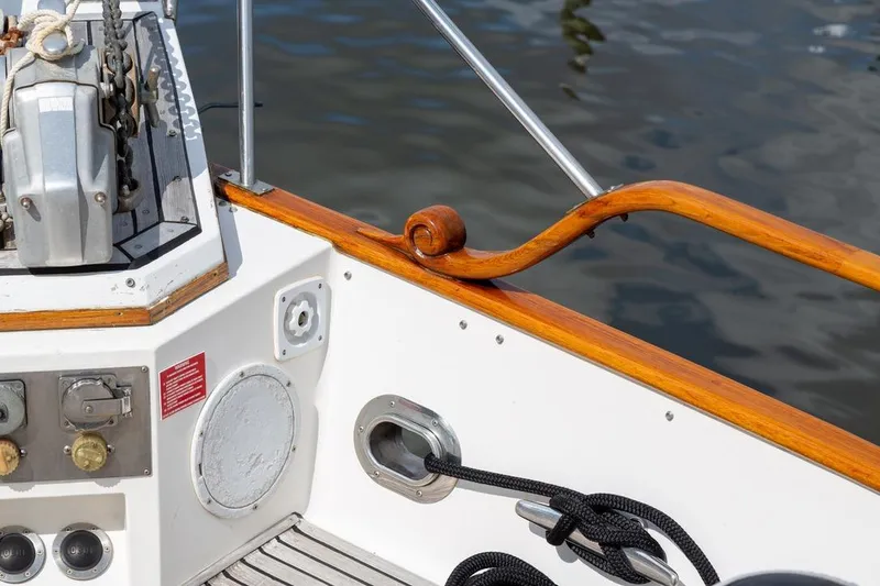 Slide: The Image of 1993 Grand Banks 46 Motoryacht deck with wood finish and marina view. - 15