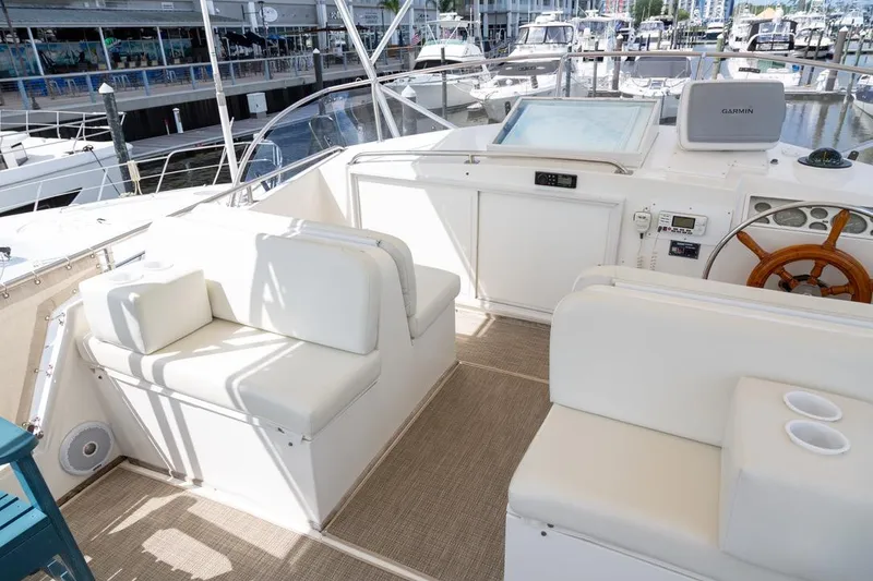 Slide: The Image of 1993 Grand Banks 46 Motoryacht helm seating area with white cushions and control panel. - 28