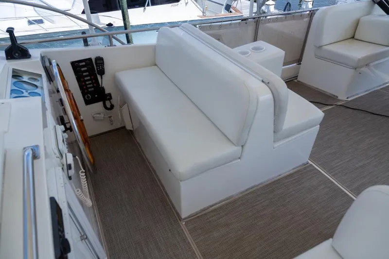 Slide: The Image of 1993 Grand Banks 46 Motoryacht interior with white seating and blue chair on deck. - 29