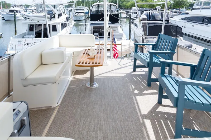 Slide: The Image of Spacious deck of 1993 Grand Banks 46 Motoryacht with seating and table under canopy. - 31