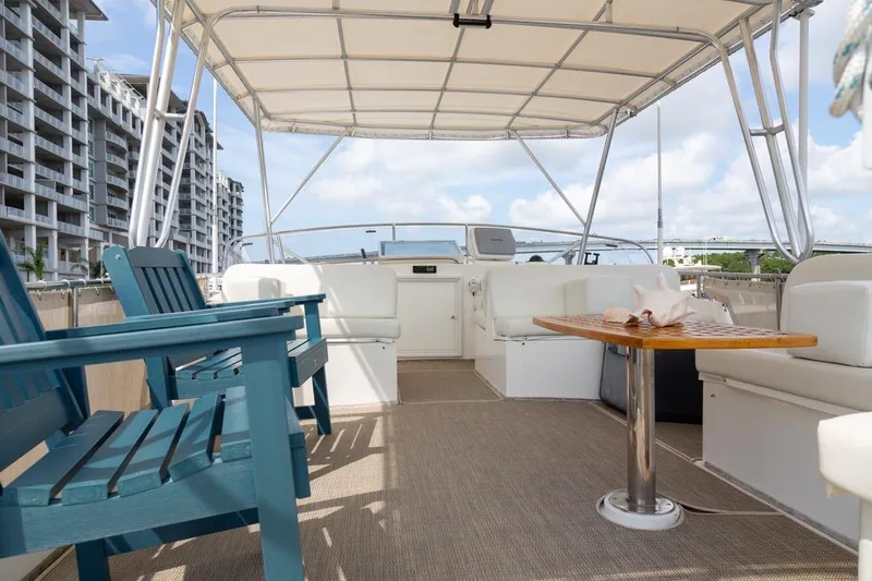 Slide: The Image of 1993 Grand Banks 46 Motoryacht helm with wooden wheel, docked in a marina. - 32