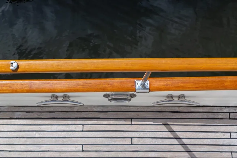 Slide: The Image of 1993 Grand Banks 46 Motoryacht docked, featuring spacious deck and American flag. - 39