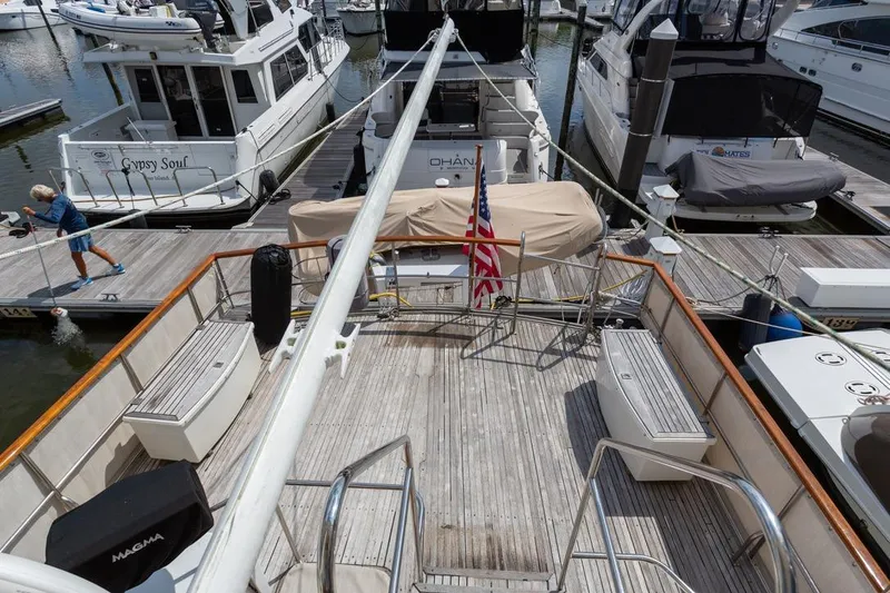 Slide: The Image of 1993 Grand Banks 46 Motoryacht docked, featuring upper deck and marina view. - 40