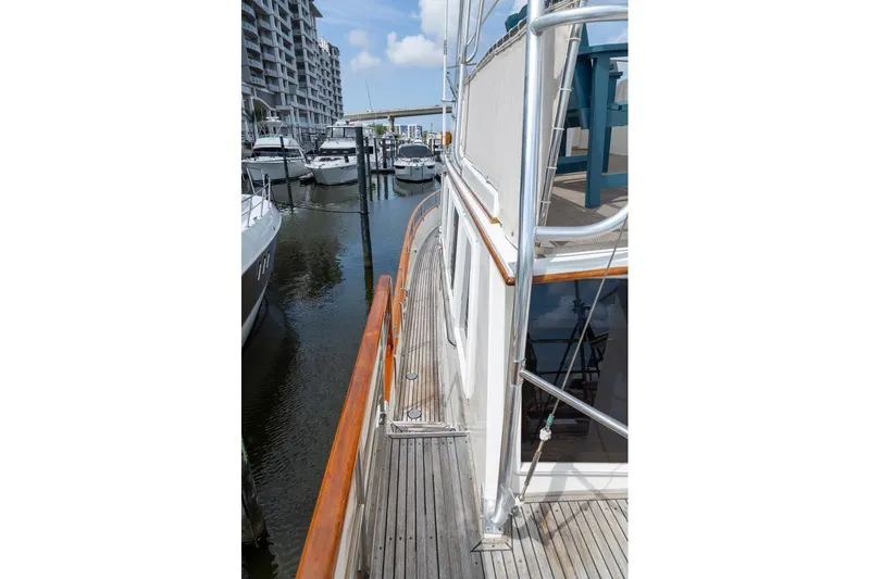 Slide: The Image of Side view of 1993 Grand Banks 46 Motoryacht docked at marina. - 42