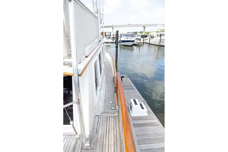 Slide: The Image of Cozy cabin interior of 1993 Grand Banks 46 Motoryacht with wooden finish and storage drawers. - 43