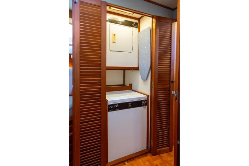 Slide: The Image of Cozy cabin interior of 1993 Grand Banks 46 Motoryacht with wooden accents and colorful pillows. - 48