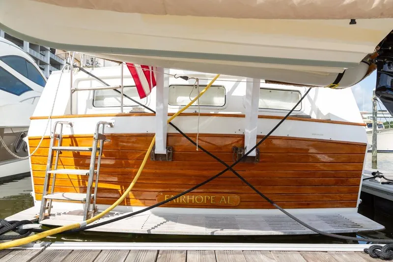 Slide: The Image of 1993 Grand Banks 46 Motoryacht docked, featuring wooden stern and ladder, Fairhope AL. - 5