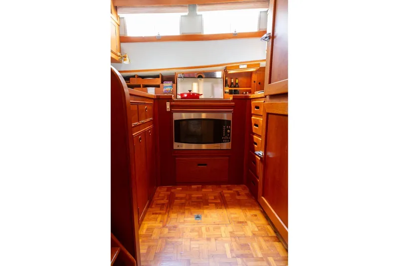 Slide: The Image of Luxurious wooden kitchen interior of 1993 Grand Banks 46 Motoryacht, featuring modern appliances. - 50
